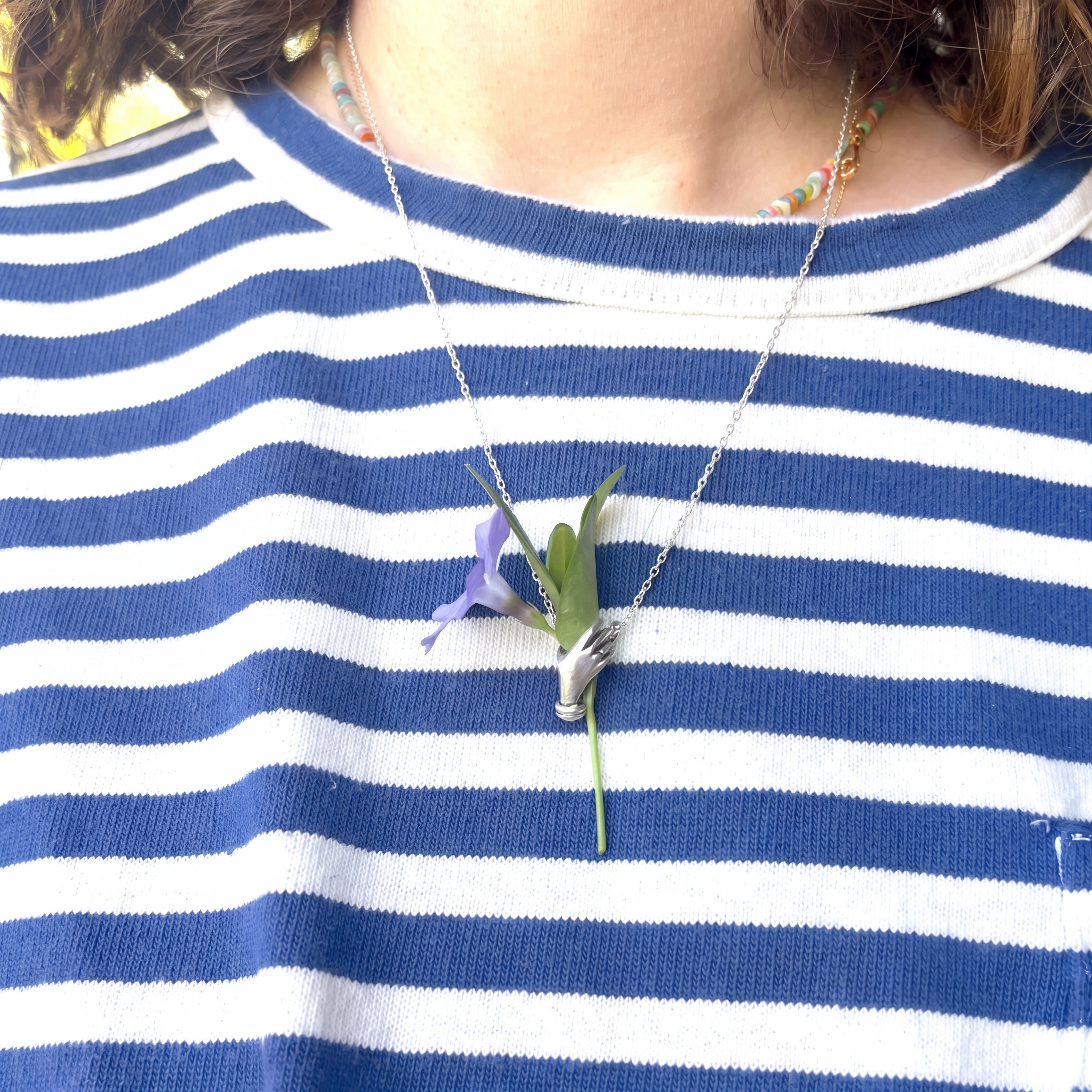 Hand Holding Flowers Necklace