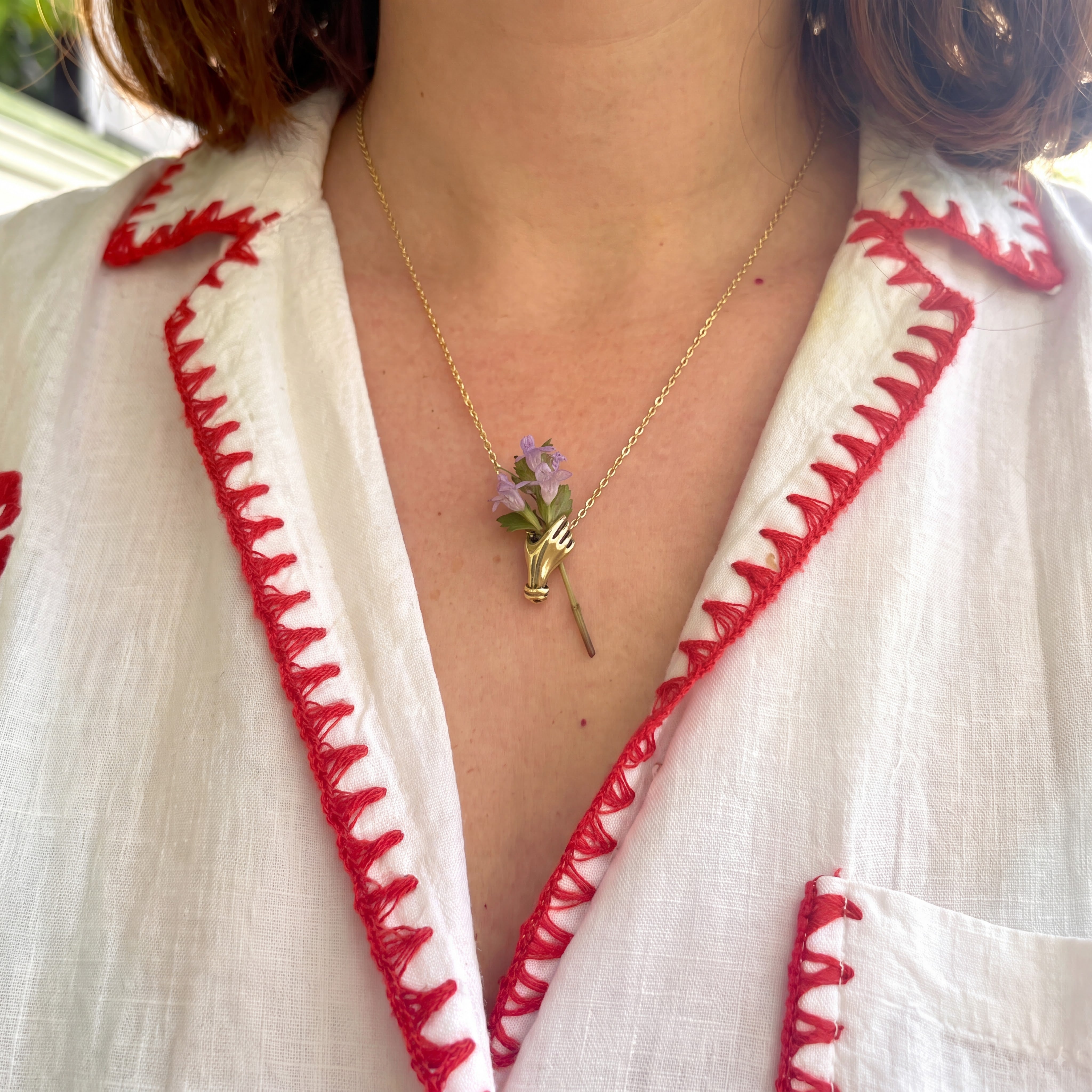 Hand Holding Flowers Necklace