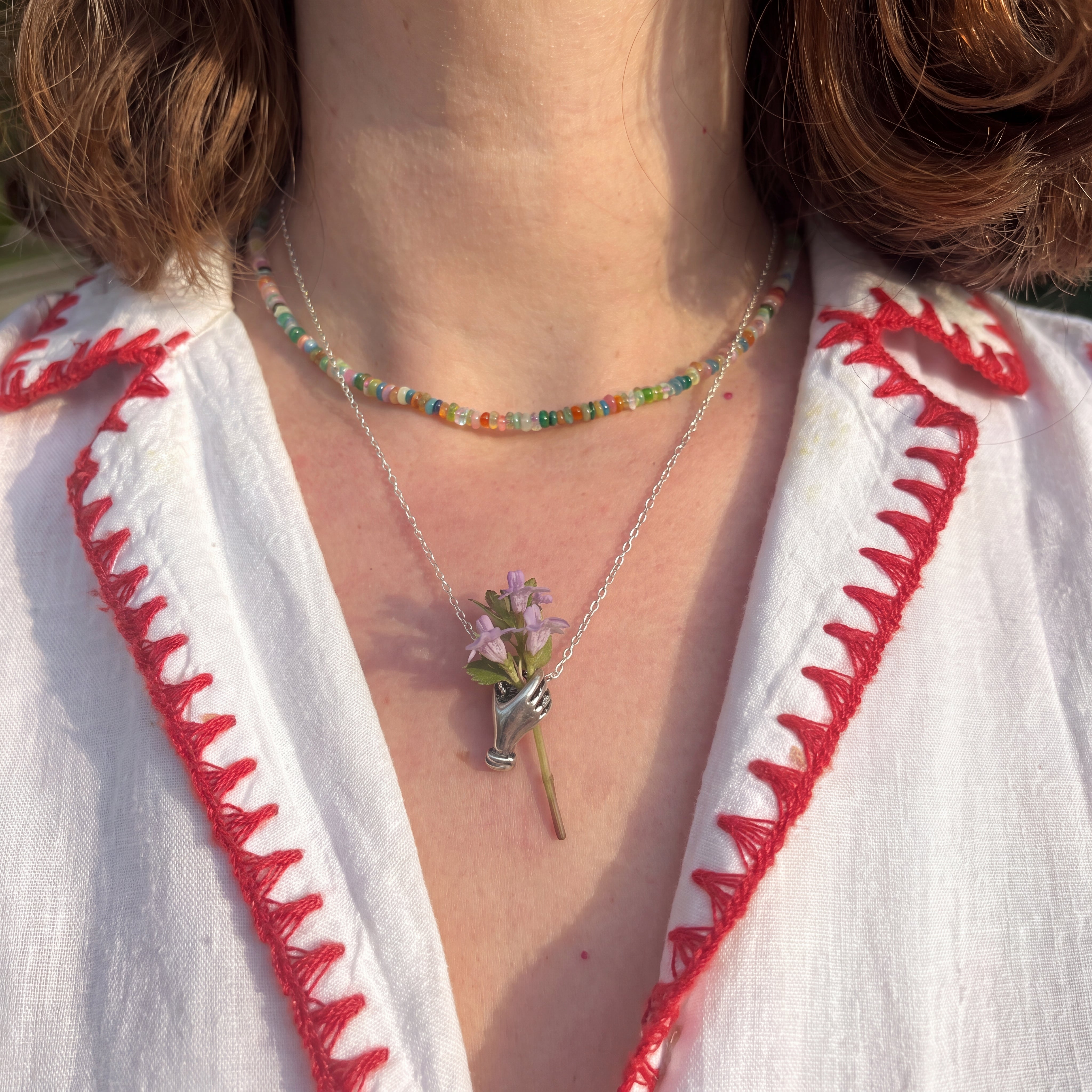 Hand Holding Flowers Necklace